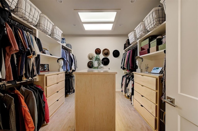 walk in closet featuring light hardwood / wood-style flooring