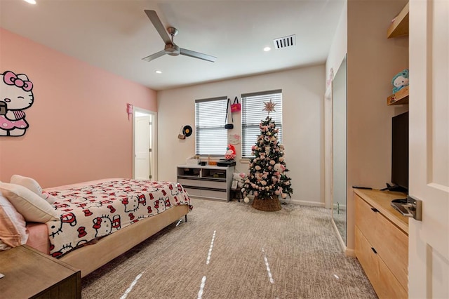 bedroom with ceiling fan and light carpet