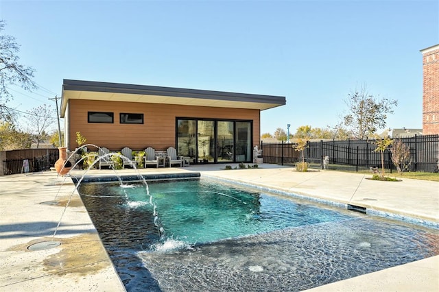 view of pool featuring pool water feature and a patio