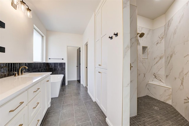 bathroom featuring tile patterned flooring, vanity, independent shower and bath, and tile walls