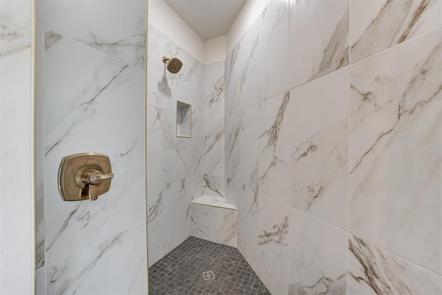 bathroom with tiled shower