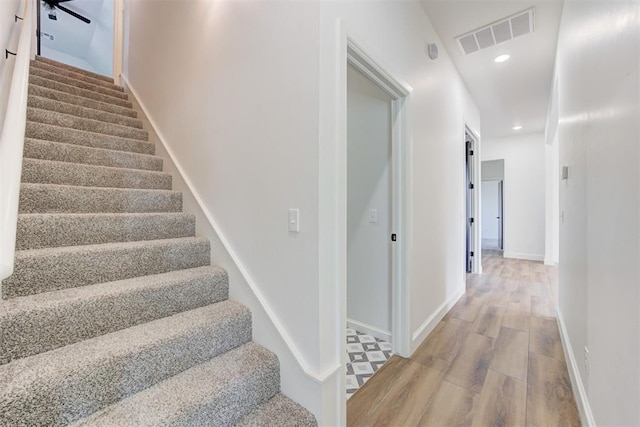 stairway featuring hardwood / wood-style flooring