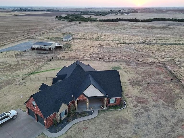 aerial view at dusk featuring a rural view