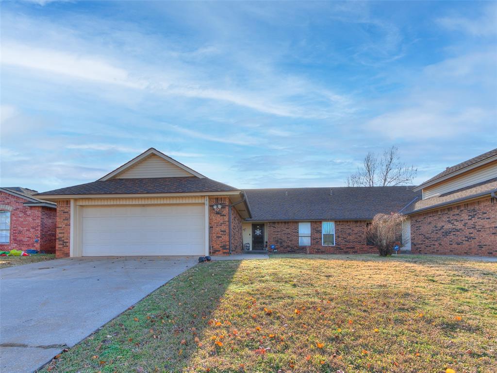 ranch-style house with a front yard and a garage