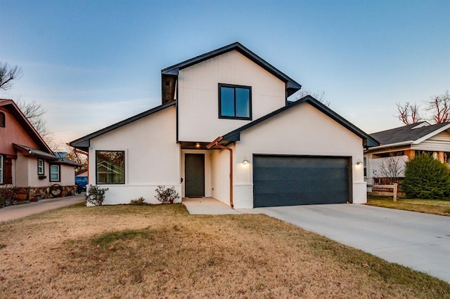 view of front of house featuring a garage and a front lawn