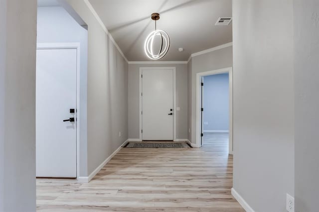 interior space with ornamental molding and light wood-type flooring