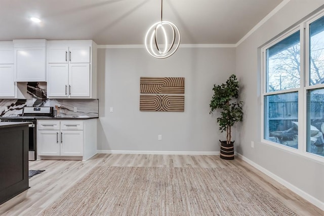 kitchen featuring tasteful backsplash, light hardwood / wood-style flooring, white cabinetry, hanging light fixtures, and stainless steel range with electric cooktop