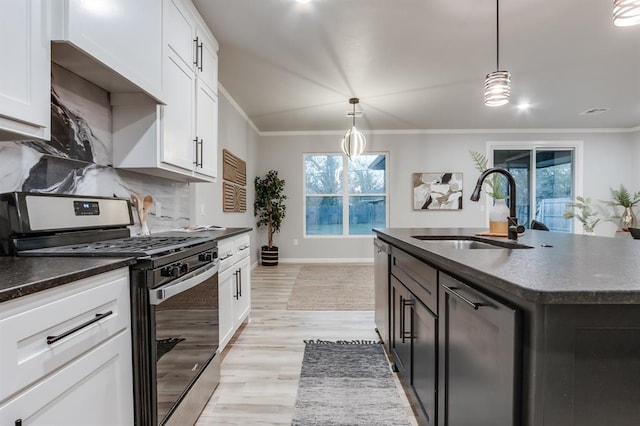 kitchen featuring pendant lighting, a center island with sink, sink, appliances with stainless steel finishes, and white cabinetry