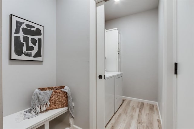 washroom with light wood-type flooring and washer and clothes dryer