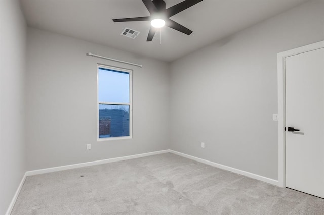 unfurnished room with ceiling fan and light colored carpet