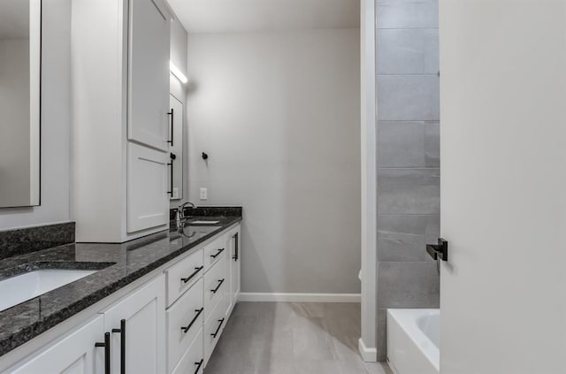 bathroom with vanity and a washtub