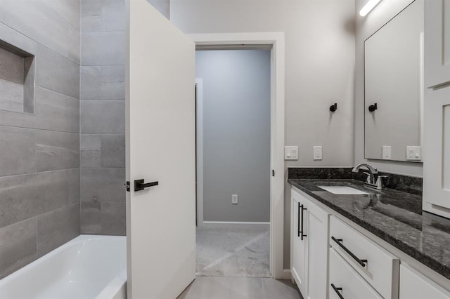 bathroom with vanity and tiled shower / bath combo