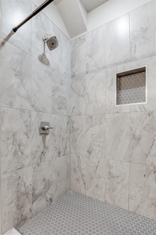 bathroom with a tile shower