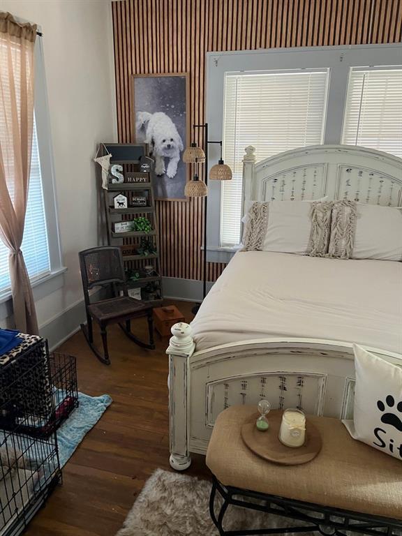 bedroom with dark wood-type flooring