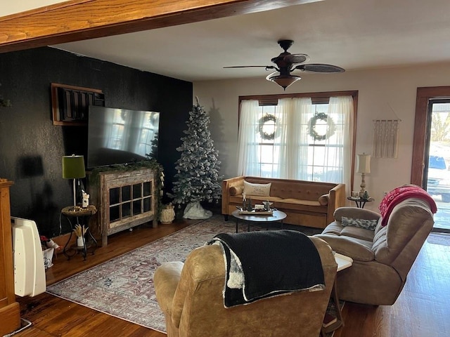 living room with dark hardwood / wood-style flooring and ceiling fan