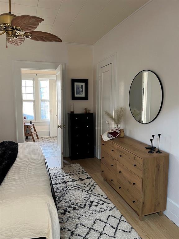 bedroom with light hardwood / wood-style floors and ceiling fan