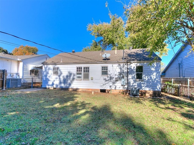 back of house with a yard and cooling unit