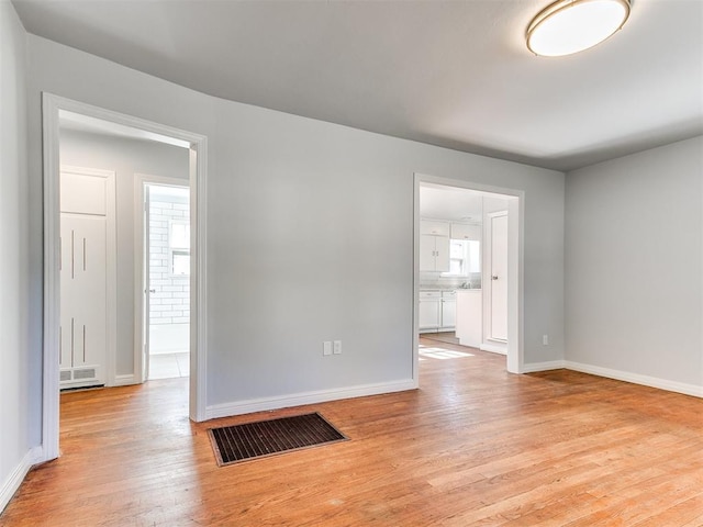 spare room with light hardwood / wood-style flooring