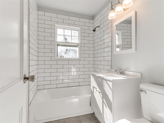 full bathroom featuring tile patterned floors, vanity, toilet, and tiled shower / bath combo