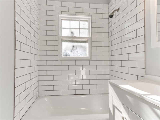 bathroom featuring vanity and tiled shower / bath combo