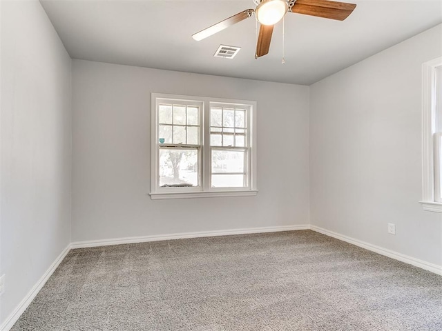 spare room featuring carpet flooring and ceiling fan