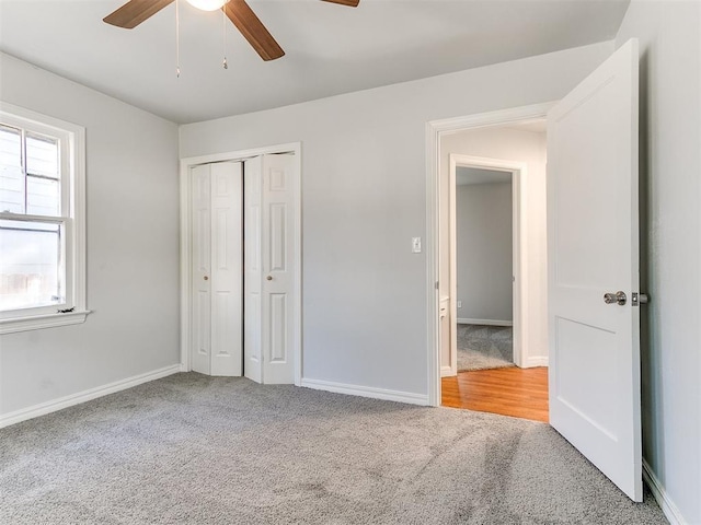 unfurnished bedroom featuring carpet, ceiling fan, and a closet