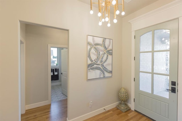 doorway to outside featuring hardwood / wood-style flooring and a notable chandelier