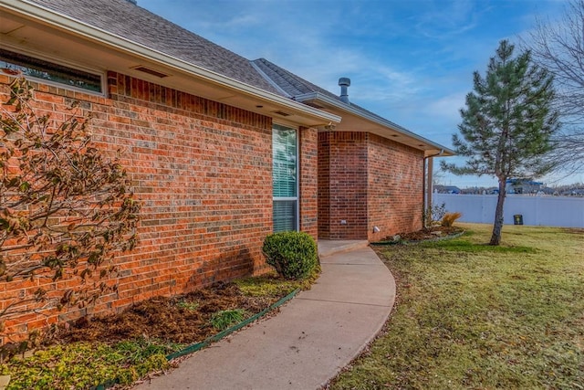 entrance to property featuring a lawn