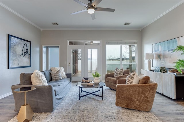 living room featuring french doors, ceiling fan, crown molding, and hardwood / wood-style floors