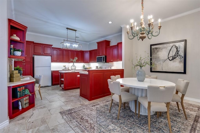 kitchen with white refrigerator, ornamental molding, a kitchen island, and pendant lighting