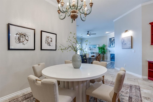 dining space with ornamental molding and ceiling fan