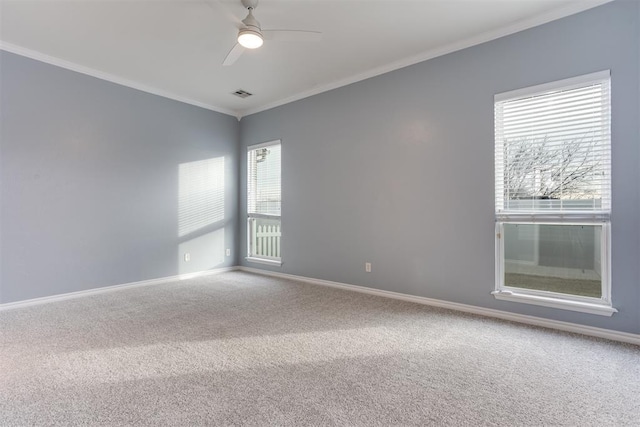 carpeted spare room featuring ornamental molding and ceiling fan