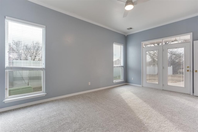 empty room with ornamental molding, carpet floors, and ceiling fan