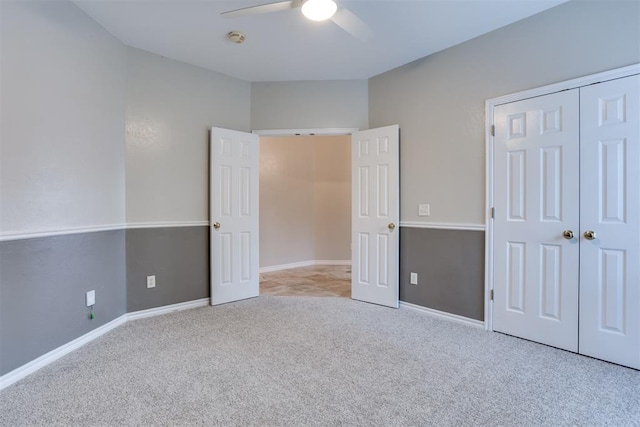 unfurnished bedroom featuring light colored carpet, ceiling fan, and a closet