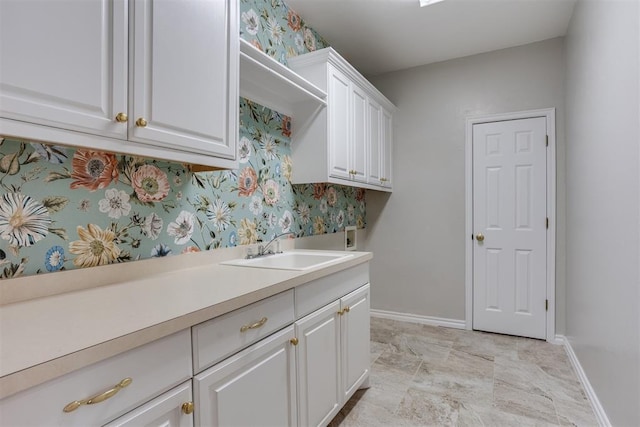 laundry area featuring cabinets, hookup for a washing machine, and sink