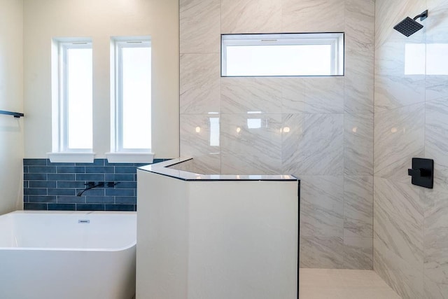 bathroom featuring a wealth of natural light, tile walls, and shower with separate bathtub