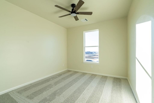 carpeted spare room with ceiling fan