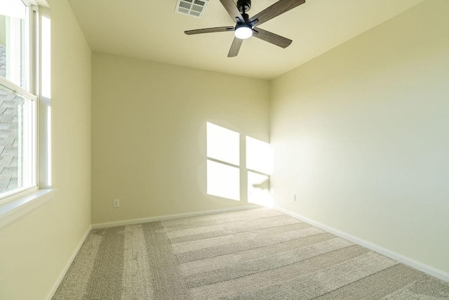 spare room with carpet floors and ceiling fan