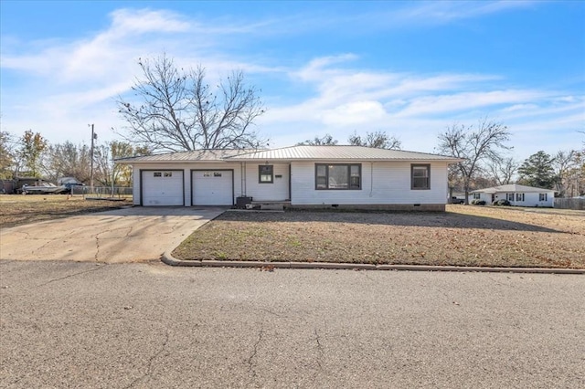 single story home with metal roof, crawl space, an attached garage, and driveway