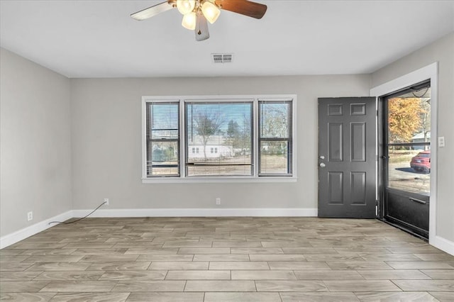 foyer with baseboards, light wood-style flooring, visible vents, and a healthy amount of sunlight