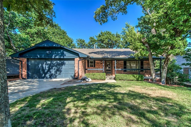 single story home featuring brick siding, concrete driveway, covered porch, an attached garage, and a front yard