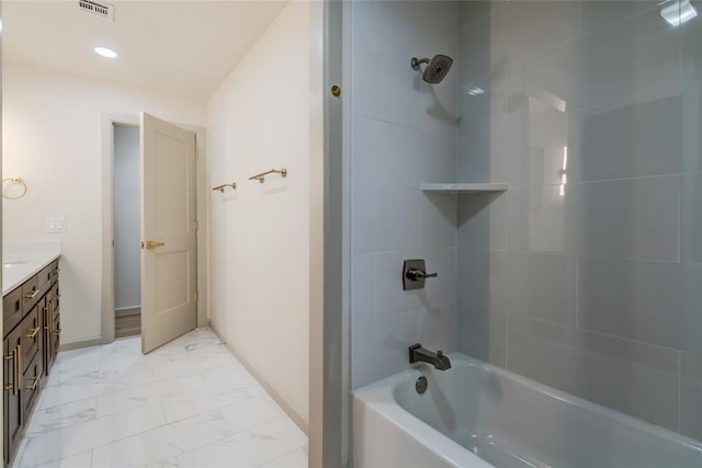 bathroom with vanity and tiled shower / bath combo