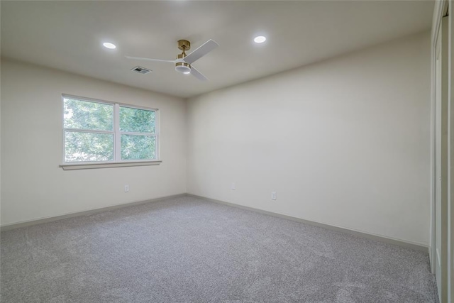 carpeted spare room featuring ceiling fan