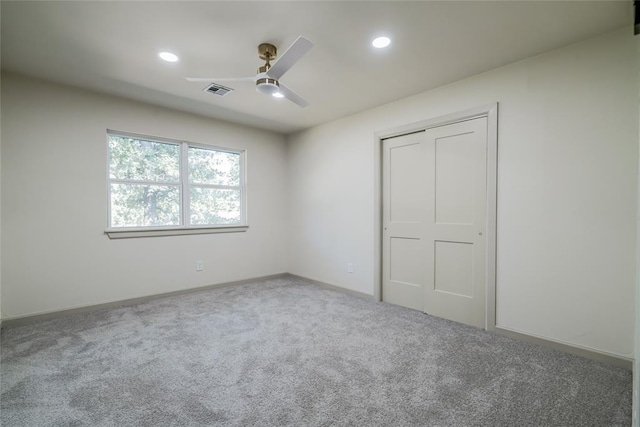 unfurnished bedroom with carpet flooring, a closet, and ceiling fan