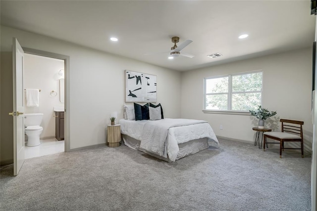 bedroom featuring ceiling fan, carpet floors, and ensuite bathroom