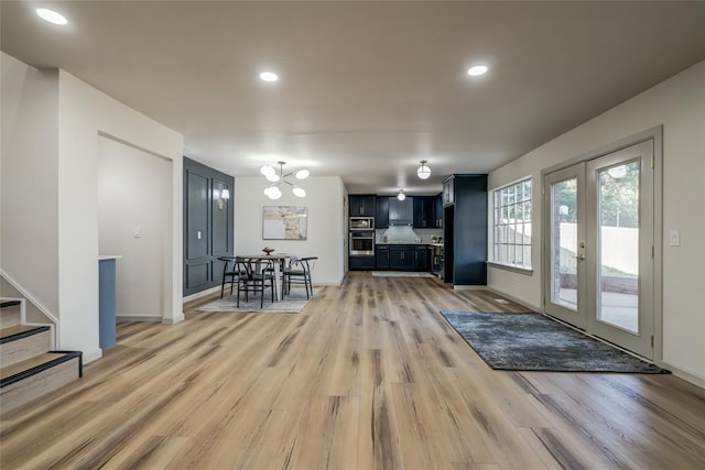 living room featuring light hardwood / wood-style flooring and french doors