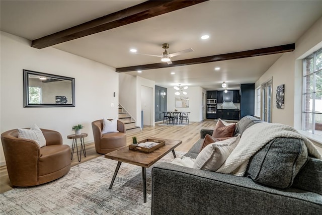 living room with hardwood / wood-style flooring, ceiling fan, and beam ceiling