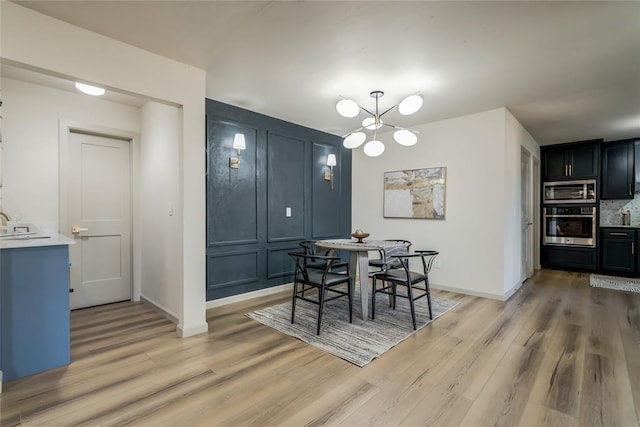 dining room featuring a chandelier and light hardwood / wood-style floors