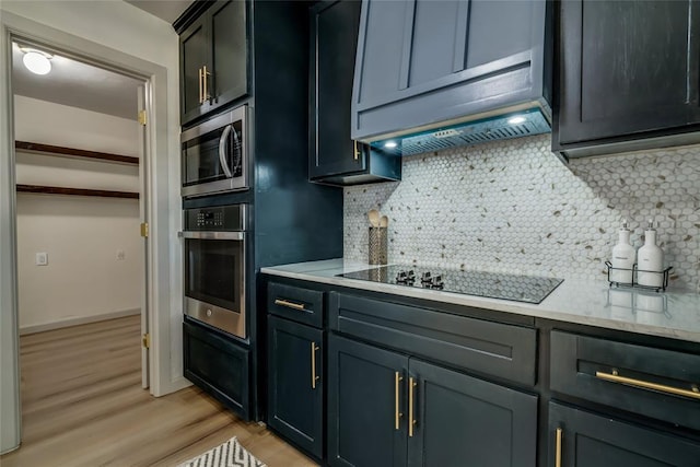 kitchen with backsplash, light hardwood / wood-style floors, and stainless steel appliances