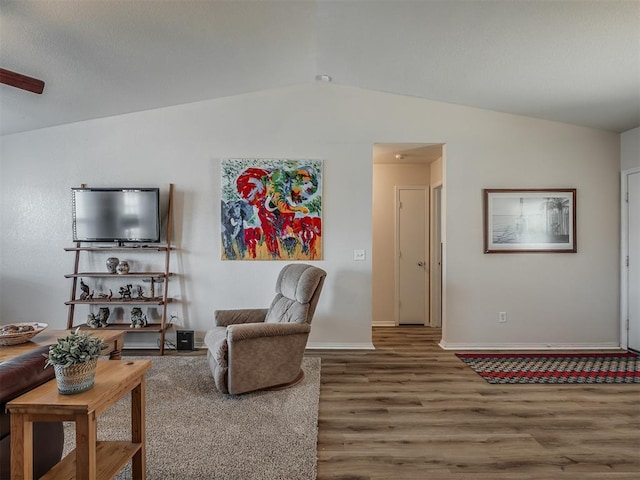 living room with wood-type flooring and vaulted ceiling